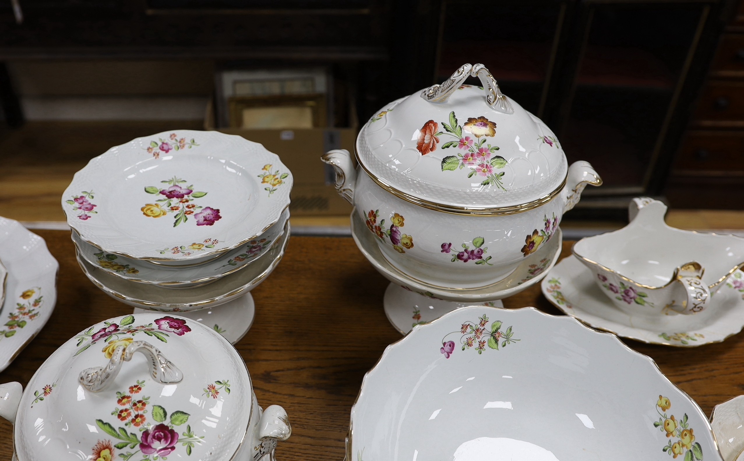 An extensive early 20th century Belgian floral painted earthenware dinner service